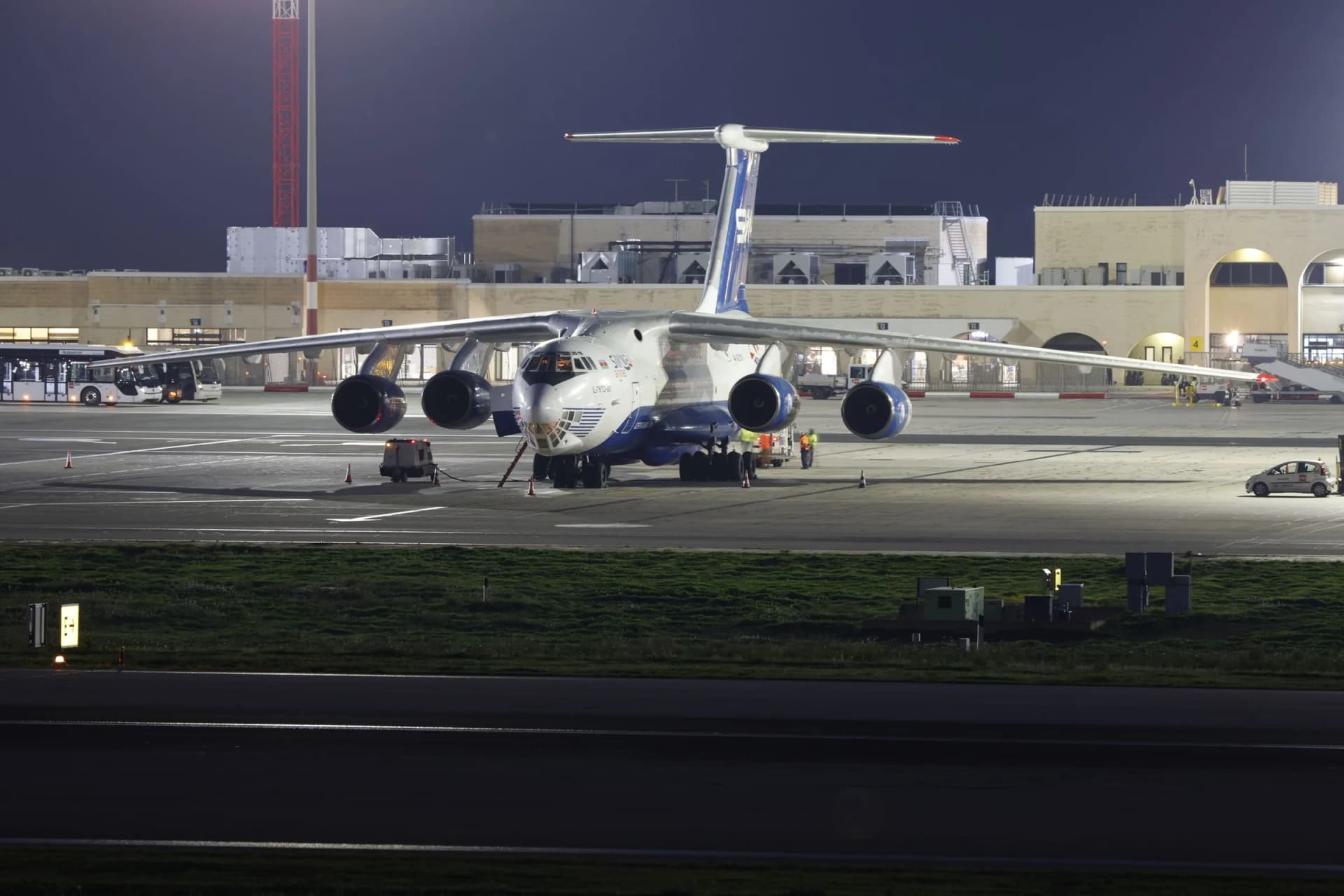 Aircraft being loaded with cargo at night