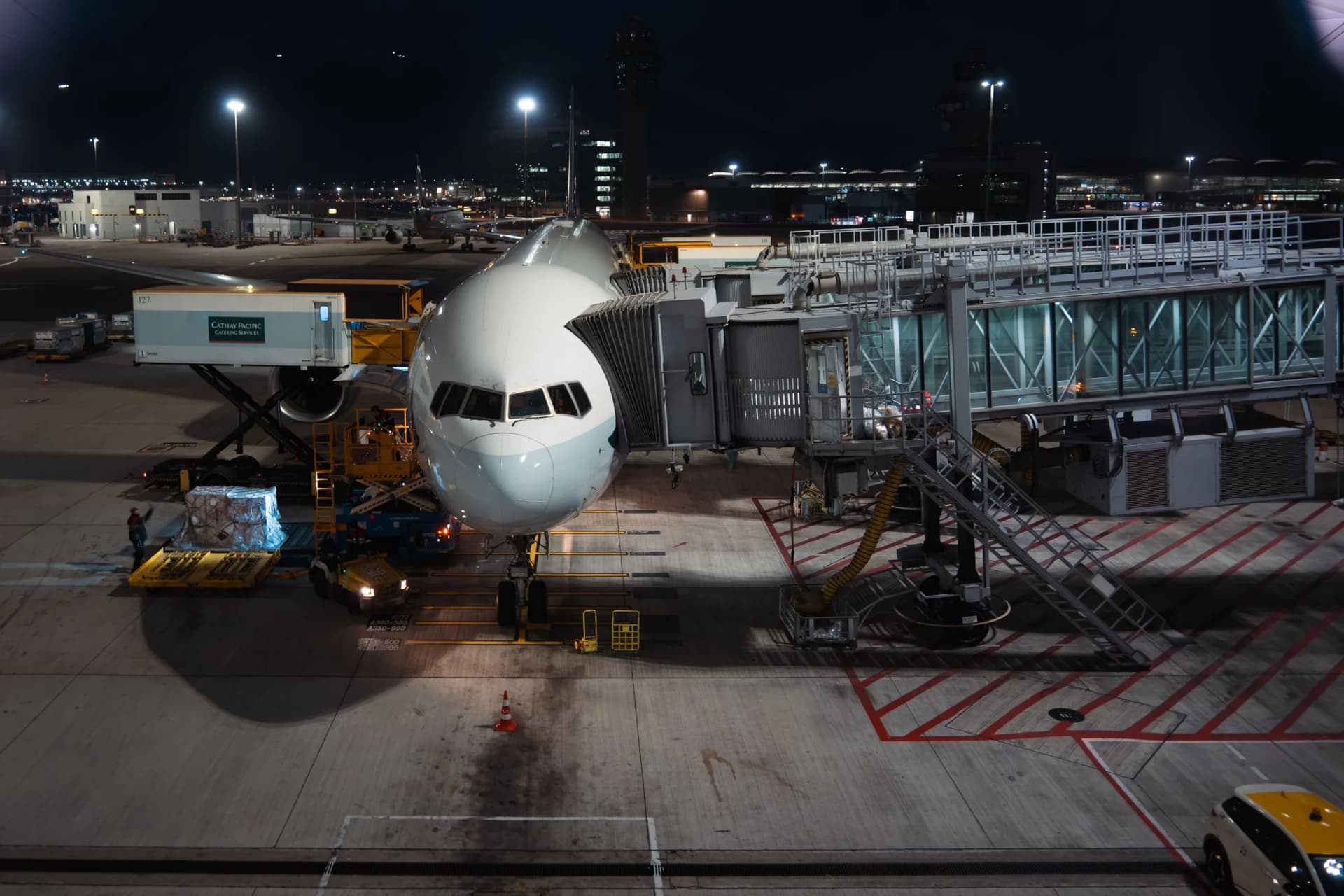 Aircraft being loaded with cargo at night